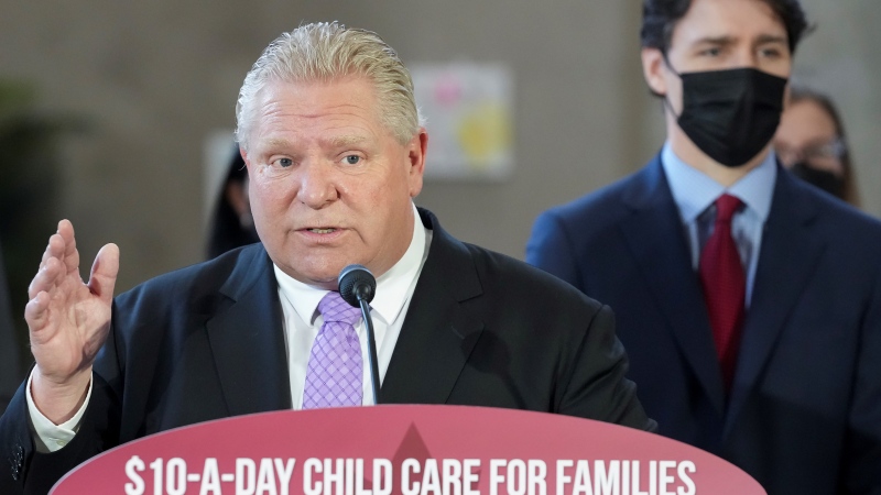 Ontario Premier Doug Ford speaks as Canadian Prime Minister Justin Trudeau listens on after reaching and agreement in $10-a-day child-care program deal in Brampton, Ont., on Monday, March 28, 2022. THE CANADIAN PRESS/Nathan Denette