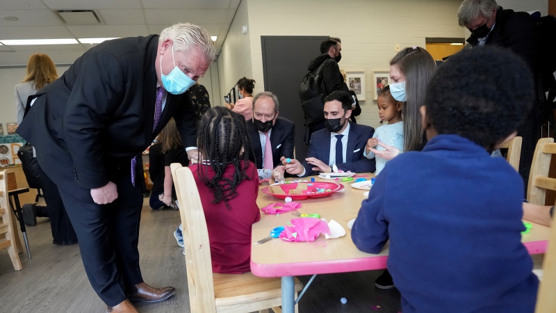 Ontario Premier Doug Ford, left, visits a daycare centre after reaching and agreement with the federal government in $10-a-day child-care program deal in Brampton, Ont., on Monday, March 28, 2022. THE CANADIAN PRESS/Nathan Denette