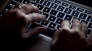 A woman uses a computer keyboard in Vancouver on Wednesday, December 19, 2012. THE CANADIAN PRESS/Jonathan Hayward