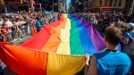 Volunteers with Pride Toronto carry a large rainbow flag during the Pride Parade in Toronto, Sunday, June 23, 2019. THE CANADIAN PRESS/Andrew Lahodynskyj