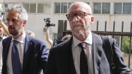 Canadian-born film director Paul Haggis, right, arrives with his lawyer Federico Straziota at Brindisi law court in southern Italy, Wednesday, June 22, 2022, to be heard by prosecutors investigating a woman's allegations he had sex with her without her consent over the course of two days. Under Italian law, a judge, after hearing arguments from both prosecutors and defense lawyers, will rule on whether Haggis can be set free pending possible additional investigation. (AP Photo/Salvatore Laporta)