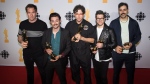 Members of the Arkells pose for a photograph at the media wall after winning Group of the Year during the 2022 Juno Awards Broadcast at the Budweiser Stage in Toronto, on Sunday, May 15, 2022. The Hamilton band offered a glimpse of what's to come for their seventh studio album "Blink Twice". THE CANADIAN PRESS/Tijana Martin