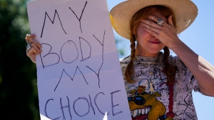 Abortion-rights advocate Eleanor Wells, 34, gets emotional during a protest in Los Angeles, Friday, June 24, 2022. The Supreme Court has ended constitutional protections for abortion that had been in place nearly 50 years in a decision by its conservative majority to overturn Roe v. Wade. (AP Photo/Jae C. Hong)