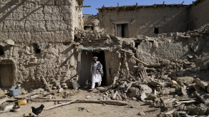A man walks out of his damaged house after an earthquake in Gayan village, in Paktika province, Afghanistan, Friday, June 24, 2022. A powerful earthquake struck a rugged, mountainous region of eastern Afghanistan early Wednesday, flattening stone and mud-brick homes in the country's deadliest quake in two decades, the state-run news agency reported. (AP Photo/Ebrahim Nooroozi)