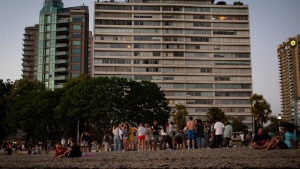 People gather at English Bay Beach amidst a heat wave, in Vancouver, B.C., on Monday, June 21, 2021. THE CANADIAN PRESS/Darryl Dyck