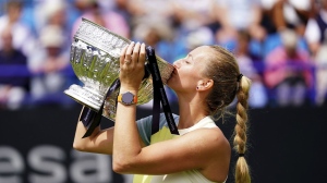 Czech Republic's Petra Kvitova celebrates with the trophy after winning the women's singles final match against Latvia's Jelena Ostapenko on day eight of the Rothesay International Eastbourne at Devonshire Park, Eastbourne, Britain, Saturday June 25, 2022. (Adam Davy/PA via AP)