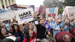 A celebration outside the Supreme Court, Friday, June 24, 2022, in Washington. The Supreme Court has ended constitutional protections for abortion that had been in place nearly 50 years — a decision by its conservative majority to overturn the court's landmark abortion cases. (AP Photo/Steve Helber)