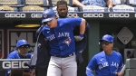 Toronto Blue Jays' Zack Collins is helped into the team's home run jacket by teammate Raimel Tapia after hitting a home run against the Kansas City Royals during the third inning of a baseball game in Kansas City, Mo., Wednesday, June 8, 2022. Collins was recalled by the Toronto Blue Jays from their triple-A affiliate in Buffalo, N.Y., on Saturday. THE CANADIAN PRESS/AP-Reed Hoffmann