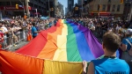Volunteers with Pride Toronto carry a large rainbow flag during the 2019 Pride Parade in Toronto, Sunday, June 23, 2019. Tens of thousands of people are expected to march in today’s Pride parade in downtown Toronto, marking the return of in-person festivities for the annual LGBTQ celebration. THE CANADIAN PRESS/Andrew Lahodynskyj