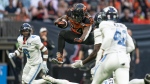 BC Lions' James Butler jumps over the tackle of Toronto Argonauts' Royce Metchie during first half of CFL football action in Vancouver, B.C., Saturday, June 25, 2022. THE CANADIAN PRESS/Rich Lam