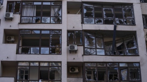 Damage at the scene of a residential building following explosions, in Kyiv, Ukraine, Sunday, June 26, 2022. Several explosions rocked the west of the Ukrainian capital in the early hours of Sunday morning, with at least two residential buildings struck, according to Kyiv mayor Vitali Klitschko. (AP Photo/Nariman El-Mofty)