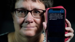 Chelle Wyatt uses her cell phone with the Otter app Friday, April 15, 2022, in Salt Lake City. People with hearing loss have adopted technology to navigate the world, especially as hearing aids are expensive and inaccessible to many.  (AP Photo/Rick Bowmer)