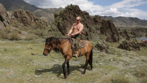 Then-Prime Minister of Russia Vladimir Putin is seen riding a horse while traveling in the mountains of the Siberian Tyva region (also referred to as Tuva), Russia, during his short vacation. G7 leaders gathering in Germany to discuss increasing the pressure on Vladimir Putin over the war in Ukraine are also taking aim at the Russian president's penchant for taking off his shirt. THE CANADIAN PRESS/AP-Kremlin Pool Photo, Sputnik, Alexei Druzhinin