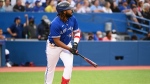 Toronto Blue Jays' first baseman Vladimir Guerrero Jr watchers his 2 RBI home run, scoring teammate Bo Bichette, not shown, clear the wall in third inning American League baseball action against the Boston Red Sox in Toronto on Monday June 27, 2022. THE CANADIAN PRESS/Jon Blacker