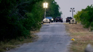 Police protect the scene where officials say dozens of people have been found dead and multiple others were taken to hospitals with heat-related illnesses after a semitrailer containing suspected migrants was found, Tuesday, June 28, 2022, in San Antonio. (AP Photo/Eric Gay)