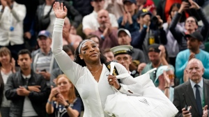 Serena Williams of the US waves as she leaves the court after losing to France's Harmony Tan in a first round women's singles match on day two of the Wimbledon tennis championships in London, Tuesday, June 28, 2022. (AP Photo/Alberto Pezzali)