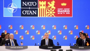 NATO Secretary General Jens Stoltenberg center, flanked by Spanish Prime Minister Pedro Sanchez, right, and U.S President Joe Biden open the first plenary session of the NATO summit in Madrid, Wednesday, June 29, 2022. North Atlantic Treaty Organization heads of state will meet for a NATO summit in Madrid from Tuesday through Thursday. (Bertrand Guay, Pool via AP)