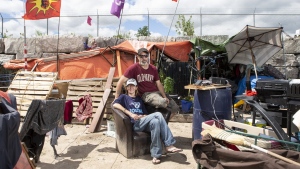 Will House and Jen Draper are photographed outside their home at a large homeless encampment, in Kitchener, Ont., on Monday June 27, 2022. THE CANADIAN PRESS/Chris Young
