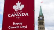 Signs are pictured on Parliament Hill prior to Canada Day, in Ottawa on Monday, June 27, 2022. Many communities are reimagining Canada Day celebrations to recognize Indigenous people as the country continues to reckon with its legacy following the discovery of possible unmarked graves at former residential schools. THE CANADIAN PRESS/Sean Kilpatrick