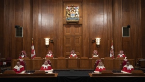 Justices of the Supreme Court pose for a photo sitting in the Supreme Court following a welcoming ceremony, Thursday, October 28, 2021 in Ottawa. The Supreme Court of Canada will issue a constitutional ruling today about extensions to Canada's rape shield laws that were enacted after the high profile trial of former CBC radio personality Jian Ghomeshi.THE CANADIAN PRESS/Adrian Wyld