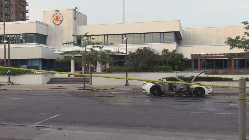 A car is seen heavily damaged following an explosion in front of a police station in Oshawa.