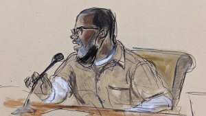 In this courtroom sketch, R. Kelly briefly addresses Judge Ann Donnelly during his sentencing in federal court, Wednesday, June 29, 2022, in New York. R. Kelly was sentenced to 30 years in prison Wednesday for using his superstardom to subject young fans — some just children — to systematic sexual abuse. (AP Photo/Elizabeth Williams)