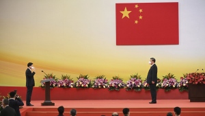 China's President Xi Jinping, right, looks on as Hong Kong's incoming Chief Executive John Lee is sworn in as the city's new leader, during a ceremony to inaugurate the city's new government in Hong Kong Friday, July 1, 2022, on the 25th anniversary of the city's handover from Britain to China. (Selim Chtayti/Pool Photo via AP)