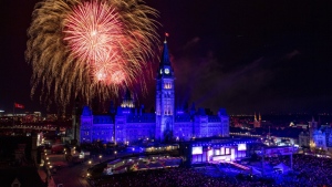 FILE - Fireworks explode above the Peace Tower and Centre Block during Canada Day celebrations on Parliament Hill in Ottawa on Monday, July 1, 2019. THE CANADIAN PRESS/Justin Tang