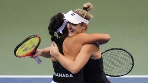 Canada's Gabriela Dabrowski, right, and Carol Zhao celebrate after defeating Latvia's Daniela Vismane and Darja Semenistaja during a Billie Jean King Cup qualifier doubles tennis match, in Vancouver, on Saturday, April 16, 2022. Dabrowski and partner Giuliana Olmos of Mexico advanced to the third round of the Wimbledon women's doubles tournament with a 7-5, 3-6, 6-3 win over Ukraine's Marta Kostyuk and Czech partner Tereza Martincová on Friday. THE CANADIAN PRESS/Darryl Dyck