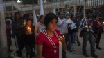 Residents hold a candlelight vigil to pray for three local teenagers in hopes they are not among the 53 migrants who died in a stifling, abandoned trailer in Texas, in San Marcos Atexquilapan, Veracruz state, Mexico, late Thursday, June 30, 2022. One of the three teens, Misael, was later confirmed to have perished in the trailer while the fate of Jair and Yovani remained unknown. (AP Photo/Felix Marquez)