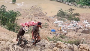 Rescuers carry the body of a victim of a mudslide in Noney, northeastern Manipur state, India, Friday, July 1, 2022. Rescuers found more bodies Friday as they resumed searching for dozens of missing after a mudslide triggered by weeks of heavy downpours killed at least 19 people at a railroad construction site in India's northeast, officials said. (AP Photo/Agui Kamei)