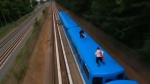 A screen grab of two men filmed train surfing on the Scarborough Rapid Transit system. (Chase TO/YouTube screenshot)