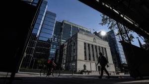 People pass the Bank of Canada building on Wellington Street in Ottawa, on Tuesday, May 31, 2022. A pair of new reports from the Bank of Canada point to rising inflation expectations by Canadian businesses and consumers. THE CANADIAN PRESS/Justin Tang
