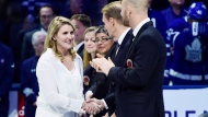Canadian women's hockey star Hayley Wickenheiser, a member of the Hockey Hall of Fame's inductee class of 2019, is greeted by members of the Hall of Fame during a ceremony ahead of NHL hockey action between the Toronto Maple Leafs and Boston Bruins in Toronto on Friday, Nov. 15, 2019. THE CANADIAN PRESS/Frank Gunn