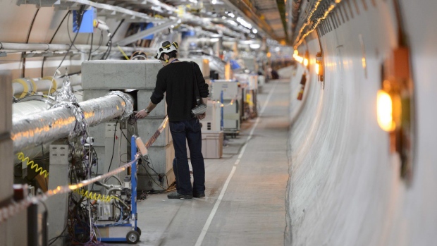 FILE - A technician works in the LHC (Large Hadron Collider) tunnel of the European Organization for Nuclear Research, CERN, during a press visit in Meyrin, near Geneva, Switzerland, Feb. 16, 2016. The physics lab that’s home to the world’s largest atom smasher announced on Tuesday, July 5, 2022 the observation of three new “exotic particles” that could provide clues about the force that binds subatomic particles together. The observation of a new type of pentaquark and the first duo of tetraquarks at CERN, the Geneva-area home to the LHC, offers a new angle to assess the so-called “strong force” that holds together the nuclei of atoms. (Laurent Gillieron/Keystone via AP, file)
