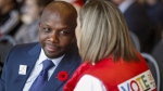 Former Olympian Donovan Bailey, centre left, speaks to a fan during a rally in support of the 2026 Winter Olympic bid in Calgary, Alta., Monday, Nov. 5, 2018. The champion sprinter is set to share his story of success on and off the track. Random House Canada announced Tuesday that it's acquired the rights to the Olympic gold medallist's memoir. THE CANADIAN PRESS/Jeff McIntosh