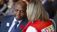 Former Olympian Donovan Bailey, centre left, speaks to a fan during a rally in support of the 2026 Winter Olympic bid in Calgary, Alta., Monday, Nov. 5, 2018. The champion sprinter is set to share his story of success on and off the track. Random House Canada announced Tuesday that it's acquired the rights to the Olympic gold medallist's memoir. THE CANADIAN PRESS/Jeff McIntosh