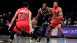 Brooklyn Nets forward Kevin Durant drives between Toronto Raptors forward Scottie Barnes and Fred VanVleet (23) during the second half of an NBA basketball game Tuesday, Dec. 14, 2021, in New York. The Nets won 131-129 in overtime. (AP Photo/Adam Hunger) 