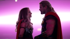 This image released by Marvel Studios shows Natalie Portman, left, and Chris Hemsworth in a scene from "Thor: Love and Thunder." (Jasin Boland/Marvel Studios-Disney via AP) 