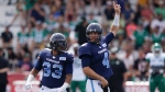 Toronto Argonauts' quarterback McLeod Bethel-Thompson, right, signals a call in front of teammate Andrew Harris looks to pass during the first half of CFL action against the Saskatchewan Roughriders at Acadia University in Wolfville, N.S., Saturday, July 16, 2022. Harris moved past Hall of Fame receiver Milt Stegall into fourth in all-time yards from scrimmage. THE CANADIAN PRESS/Darren Calabrese