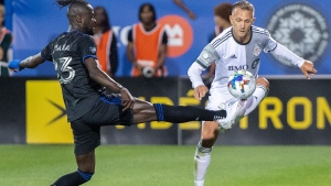 CF Montreal's Kei Kamara, left, challenges Toronto FC's Domenico Criscito during second half MLS soccer action in Montreal, Saturday, July 16, 2022. THE CANADIAN PRESS/Graham Hughes