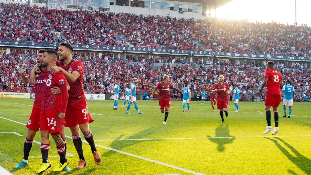 Toronto FC midfielder Jonathan Osorio (21) celebrates with teammates Lorenzo Insigne (24) and forward Jesús Jiménez (9) after scoring the first goal of the game against Charlotte FC against during  first half MLS action in Toronto on Saturday July 23, 2022.THE CANADIAN PRESS/Chris Young