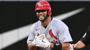 St. Louis Cardinals' Albert Pujols gestures to the dugout after hitting a double against Toronto Blue Jays starting pitcher Kevin Gausman, not shown, in the fourth inning of interleague MLB baseball action in Toronto, Wednesday, July 27, 2022. THE CANADIAN PRESS/Jon Blacker 
