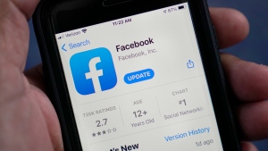 FILE - The Facebook app is shown in the app store on a smart phone in Surfside, Fla., on April 23, 2021. According to a new report from the nonprofit groups Global Witness and Foxglove, Facebook is letting violent hate speech slip through its controls in Kenya as it has in other countries. It is the third such test of Facebook's ability to detect hateful language ”either via artificial intelligence or human moderators” that the groups have run, and that the company has failed. (AP Photo/Wilfredo Lee, File)