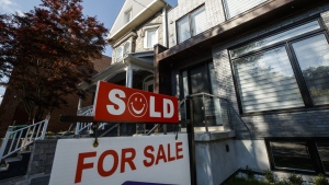 A Sold sign sits in front of a house in Toronto on Tuesday July 12, 2022. THE CANADIAN PRESS/Cole Burston