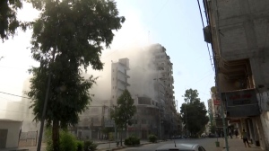 Smoke pours out of a tall building after an Israeli airstrikes in Gaza City, on Friday, Aug. 5, 2022. (AP Photo)