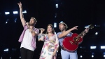 FILE - Charles Kelley, from left, Hillary Scott, and Dave Haywood of Lady A perform during CMA Fest 2022 in Nashville, Tenn., on June 12, 2022. Grammy-winning country trio Lady A are postponing their tour this year to as band member Charles Kelley focuses on sobriety. The band was due to start their tour in August in Nashville. (Photo by Amy Harris/Invision/AP, File)