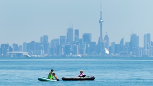 People enjoy activities on Lake Ontario overlooking the City of Toronto skyline during the COVID-19 pandemic at Jack Darling Park in Mississauga, Ont., on Wednesday, June 17, 2020. THE CANADIAN PRESS/Nathan Denette 