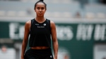 Canada's Leylah Fernandez walks to the baseline to serve against Italy's Martina Trevisan during their quarterfinal match at the French Open tennis tournament in Roland Garros stadium in Paris, France, Tuesday, May 31, 2022. (AP Photo/Thibault Camus) 