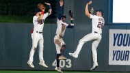 Minnesota Twins' Jake Cave, Nick Gordon and Max Kepler, from left, celebrate the team's 7-3 win over the Toronto Blue Jays in a baseball game Saturday, Aug. 6, 2022, in Minneapolis. (AP Photo/Bruce Kluckhohn)
